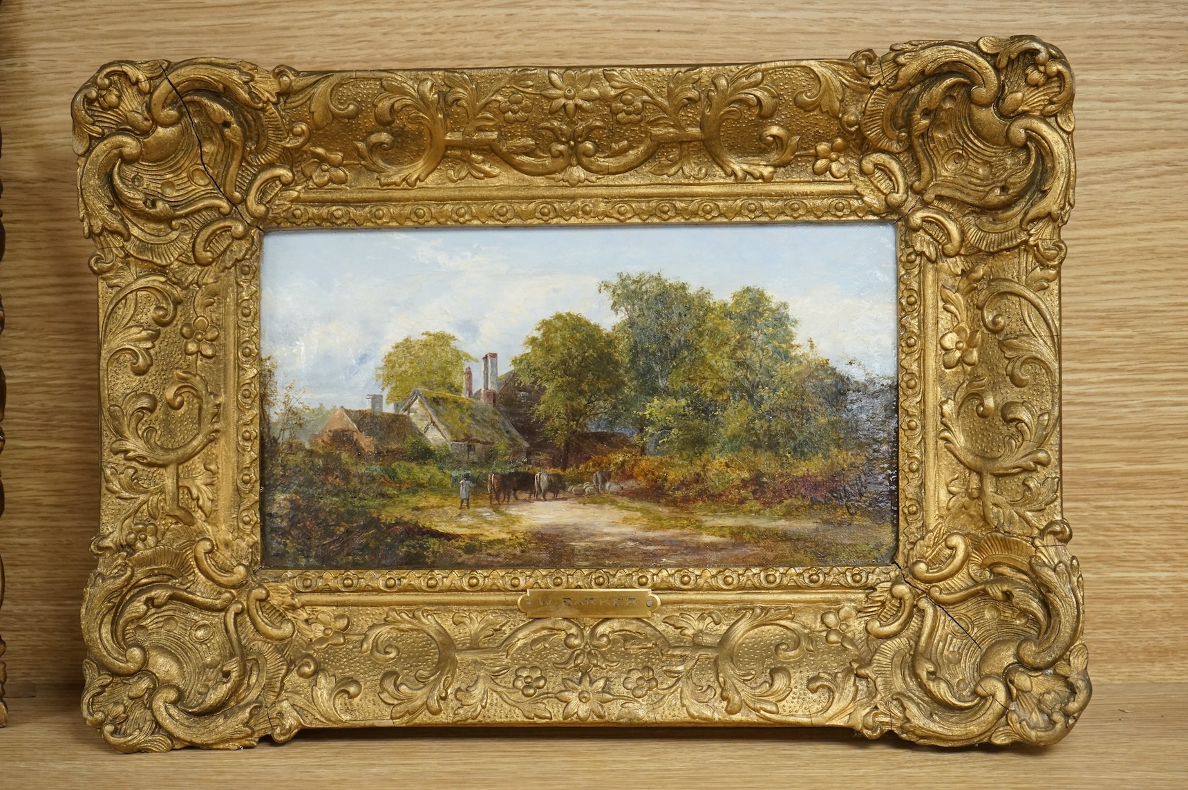 W. Barker, oil on canvas, Village scene with cattle, signed and dated 1865, ornate gilt framed, 15 x 28cm